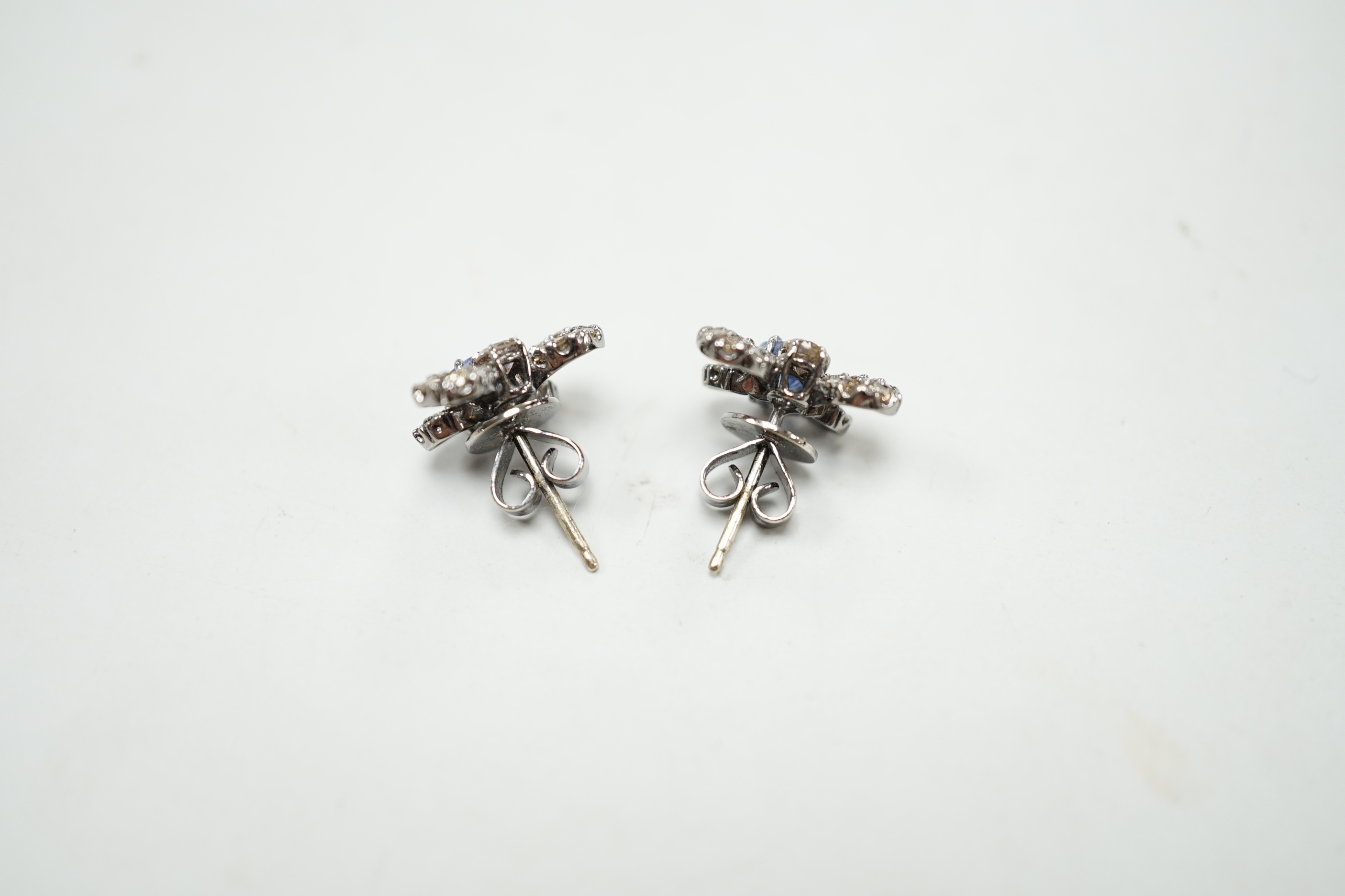 A pair of 750 white metal, sapphire and diamond cluster set bug earrings, width 13mm, gross weight 3.8 grams.